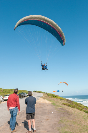 PORT ELIZABETH, SOUTH AFRICA - FEBRUARY 27, 2016:  A paraglider in the air at Beachview near Port Elizabethのeditorial素材