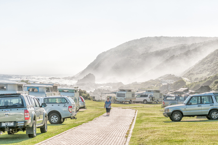 STORMS RIVER MOUTH, SOUTH AFRICA - FEBRUARY 28, 2016:  Cars and caravans at the rest camp at Storms River Mouth with fog moving in from the seaのeditorial素材