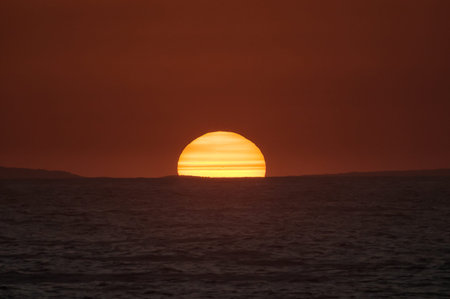 A fiery sunset over the Indian ocean on the Eastern Cape coast of South Africa. Sunspots are visibleの写真素材