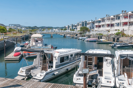 KNYSNA, SOUTH AFRICA - MARCH 3, 2016: The marina at the historic Thesens Island with luxury homes. Several types of boats, including houseboats, are visibleのeditorial素材