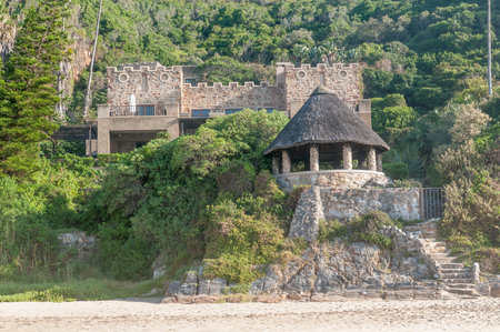 KNYSNA, SOUTH AFRICA - MARCH 5, 2016: A house on the slopes of a hill at the beach in Noetsie. Noetsie is a popular tourist attraction due to the houses that were built to look like castles.のeditorial素材