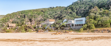 KNYSNA, SOUTH AFRICA - MARCH 5, 2016: Early morning view of houses on the slope of a hill at the beach in Noetsie, some built to look like castlesのeditorial素材