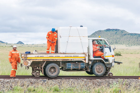 MIDDELBURG, SOUTH AFRICA - MARCH 8, 2016: Unidentified railroad maintenance workers with a truck modified to drive on railroad tracksのeditorial素材