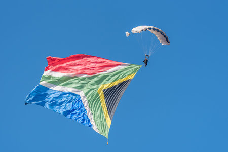 BLOEMFONTEIN, SOUTH AFRICA - JULY 16, 2016: An unidentified skydiver with a big South African flag in a public display at the Tempe Airport at Bloemfonteinのeditorial素材
