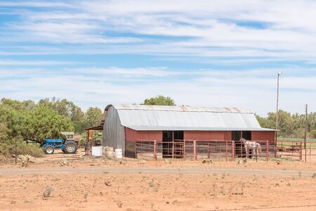 JACOBSDAL, SOUTH AFRICA - DECEMBER 24, 2016: A farm scene with tractor, barn and horse near Jacobsdal, a small town in the Free State Provinceのeditorial素材