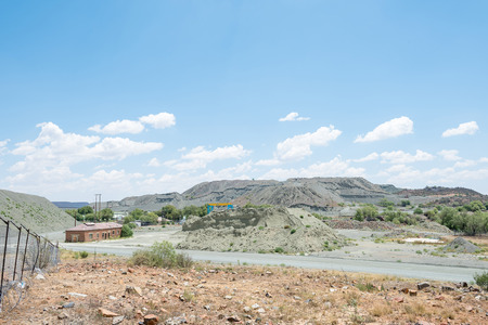 JAGERSFONTEIN, SOUTH AFRICA - DECEMBER 31, 2016: Mine dumps and infrastructure in Jagersfontein. The town claims the title of oldest mining town in South Africa and biggest hand dug hole in the worldのeditorial素材