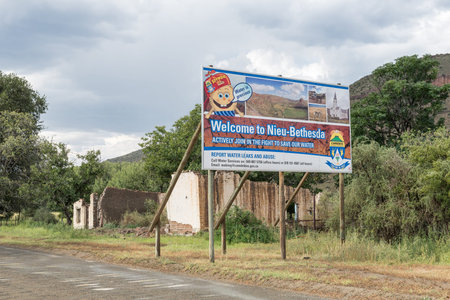 NIEU BETHESDA, SOUTH AFRICA - MARCH 21, 2017: A welcome sign and ruin at the entrance to...