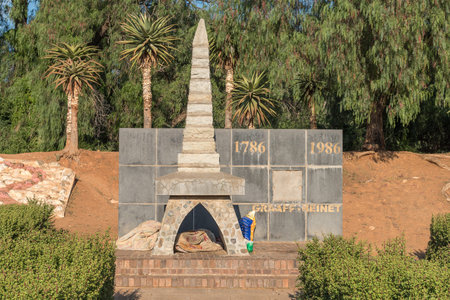 A monument at the entrance to Graaff Reinet being used as shelter for a homeless personの写真素材