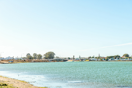 VELDDRIF, SOUTH AFRICA - APRIL 1, 2017: View of a bridge over part of the Berg River with Velddrif in the backのeditorial素材