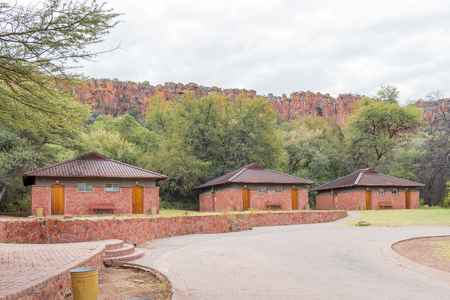 WATERBERG PLATEAU NATIONAL PARK, NAMIBIA - JUNE 19, 2017: Chalets in the rest camp in the Waterberg Plateau National Park with the plateau in the backのeditorial素材