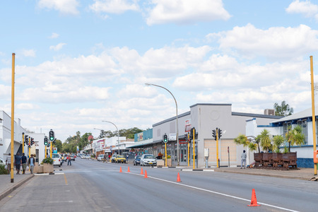 TSUMEB, NAMIBIA - JUNE 20, 2017: A street scene with businesses and vehicles in Tsumeb in the Oshikoto Region of Namibiaのeditorial素材
