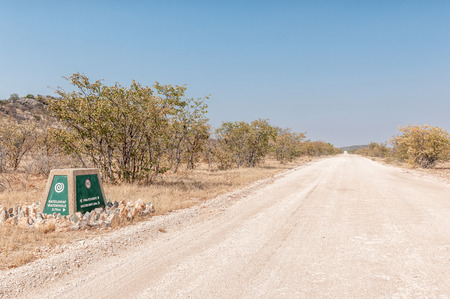 ETOSHA NATIONAL PARK, NAMIBIA - JUNE 27, 2017: A distance marker at the Rateldraf turn-off in the Western part of the Etosha National Park in Namibiaのeditorial素材