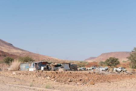 BERGSIG, NAMIBIA - JUNE 28, 2017: A street scene with shacks and car wrecks in Bergsig, a small village in the Kunene Region of Namibiaのeditorial素材