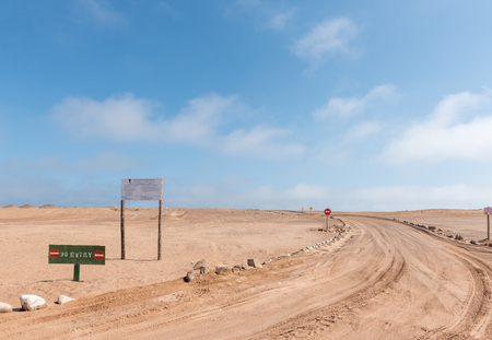 SKELETON COAST NATIONAL PARK, NAMIBIA - JUNE 28, 2017: No entry sign and road to a diamond mining area between Henties Bay and Torra Bay in the Skeleton Coast area of Namibiaのeditorial素材