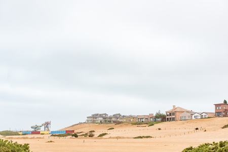 HENTIES BAY, NAMIBIA - JUNE 29, 2017: Houses on a dune and a waterpark in Henties Bay, a holiday town on the Skeleton Coast of Namibiaのeditorial素材