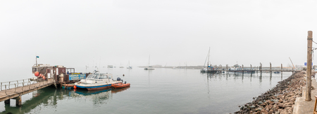 WALVIS BAY, NAMIBIA - JULY 1, 2017: A misty panorama of the yacht harbor in Walvis Bay on the Atlantic Coast of Namibiaのeditorial素材