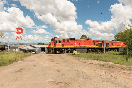 FICKSBURG, SOUTH AFRICA - MARCH 12, 2018: A train crossing a road full of potholes in Ficksburg in...