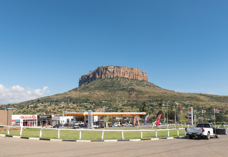 QWAQWA, SOUTH AFRICA - MARCH 14, 2018: A street scene with gas station and vehicles in Phuthaditjhaba in QwaQwa in the Free State Provinceのeditorial素材