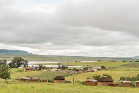 ZWELISHA, SOUTH AFRICA - MARCH 18, 2018: Houses and small scale farming in Zwelisha, next to road P288 in the Kwazulu-Natal Drakensberg. The Woodstock dam is visibleのeditorial素材