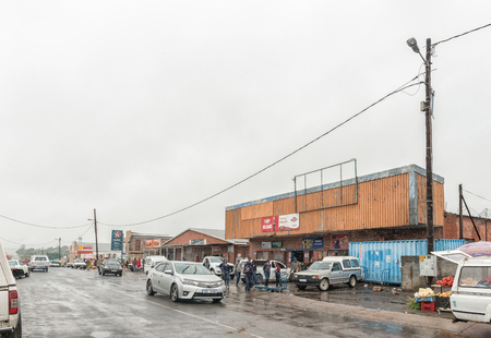 POMEROY, SOUTH AFRICA - MARCH 22, 2018: A street scene with businesses, vehicles and people in Pomeroy in the Kwazulu-Natal Province. Falling rain is visibleのeditorial素材
