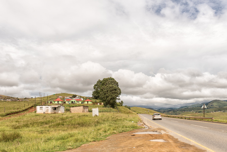 BULWER, SOUTH AFRICA - MARCH 23, 2018: Small farms with houses and corn fields next to road R617 near Bulwer in the Kwazulu-Natal Province of South Africaのeditorial素材