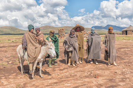 BLACK MOUNTAIN PASS, LESOTHO - MARCH 24, 2018: Unidentified Basotho people in traditional clothes in the Mamokae village. A donkey is visibleのeditorial素材