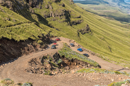 SANI PASS, SOUTH AFRICA - MARCH 24, 2018: Hairpin bends in the Sani Pass. Four-wheel drive vehicles are visible on one of the hairpin bendsのeditorial素材