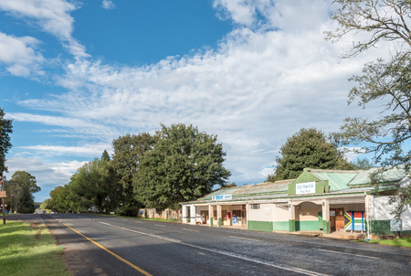 HIMEVILLE, SOUTH AFRICA - MARCH 25, 2018: A street scene with a mini mall in Himeville in the Kwazulu-Natal Province. The old post office and a liquor store are visibleのeditorial素材