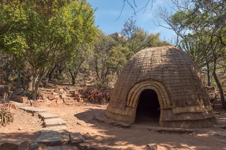 PRETORIA, SOUTH AFRICA, JULY 31, 2018: A replica Zulu hut in the forest at the Voortrekker Monument on Monument Hill in Pretoriaのeditorial素材