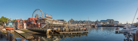 CAPE TOWN, SOUTH AFRICA, AUGUST 9, 2018:  Panorama of the harbor and the Victoria and Alfred Waterfront in Cape Town in the Western Cape Province. Yachts, businesses and a ferris wheel are visibleのeditorial素材