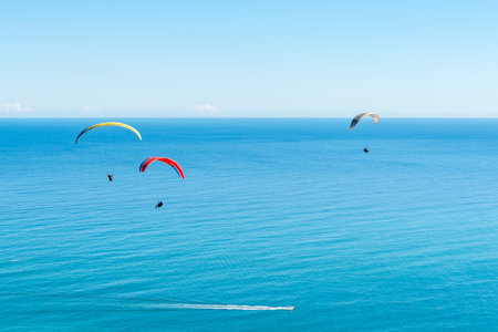 Three tandem paragliders above Sea Point after launch from Signal Hill in Cape Town in the Western...