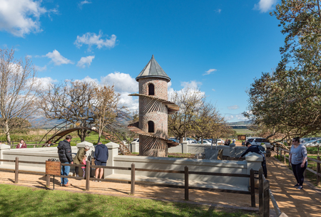 PAARL, SOUTH AFRICA, AUGUST 10, 2018: The goat tower and bridge ar Fairview wine and cheese farm near Paarl in the Western Cape Province Goats and people are visibleのeditorial素材