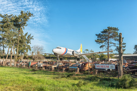 BELLVILLE, SOUTH AFRICA, AUGUST 15, 2018: A Convair Aeroplane and vintage cars waiting to be...