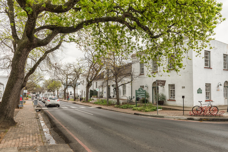 STELLENBOSCH, SOUTH AFRICA, AUGUST 16, 2018: Historic buildings in Dorp street in Stellenbosch in the Western Cape Province. A book shop and vehicles are visibleのeditorial素材