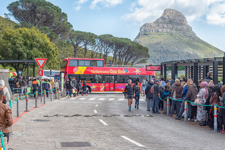 CAPE TOWN, SOUTH AFRICA, AUGUST 17, 2018: Queues of people at the lower cable station at Table mountain in Cape Town in the Western Cape Province. Lions Head and a CitySightseeing bus are visibleのeditorial素材