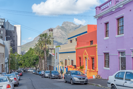 CAPE TOWN, SOUTH AFRICA, AUGUST 17, 2018: A street scene, with multi-colored houses, in the Bo-Kaap in Cape Town in the Western Cape Province. The Auwal Masjid and Devils Peak are visible in the backのeditorial素材