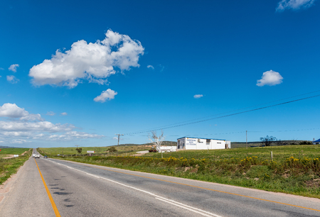 ST HELENA BAY, SOUTH AFRICA, AUGUST 21, 2018: A road landscape, with a butchery and vehicles, near St Helena Bay on the Atlantic Ocean Coastのeditorial素材