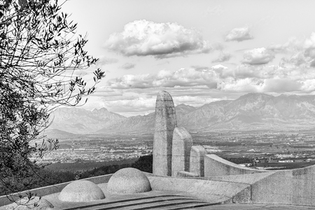 PAARL, SOUTH AFRICA, AUGUST 10, 2018: View of part of the Afrikaans Language Monument at Paarl in the Western Cape Province. Paarl and the Hottentots-Holland Mountains are visible in the back. Monochromeのeditorial素材