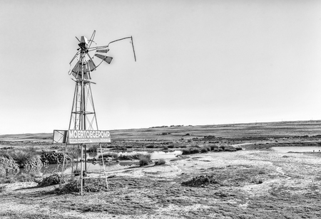 VREDENBURG, SOUTH AFRICA, AUGUST 21, 2018: A funny sign on a broken windmill near Vredenburg in the Western Cape Province. Monochromeのeditorial素材