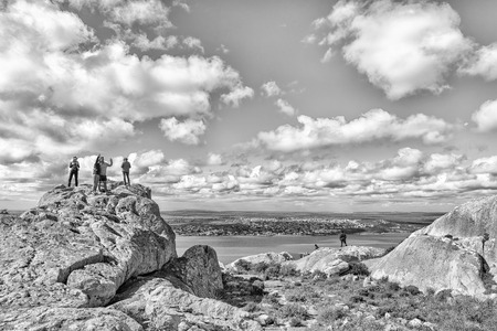 WEST COAST NATIONAL PARK, SOUTH AFRICA, AUGUST 20, 2018: Tourists at the Perlemoen Lookout Point at Postberg near Langebaan on the Atlantic Ocean coast. Langebaan is visible in the back. Monochromeのeditorial素材