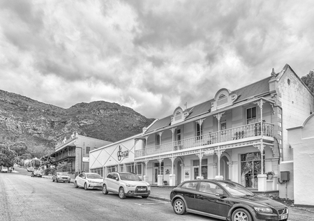PIKETBERG, SOUTH AFRICA, AUGUST 22, 2018: A street scene, with historic buildings, businesses and vehicles, in Piketberg in the Swartland region of the Western Cape Province. Monochromeのeditorial素材