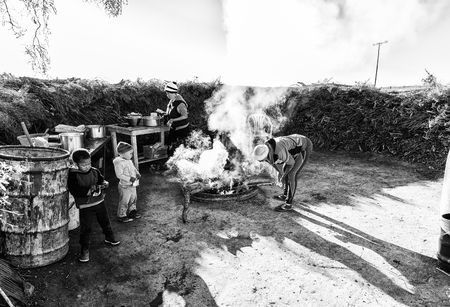 NIEUWOUDTSVILLE, SOUTH AFRICA, AUGUST 29, 2018: An outdoor kitchen at Matjiesfontein farm near Nieuwoudtville in the Northern Cape Province. People are visible. Monochromeのeditorial素材
