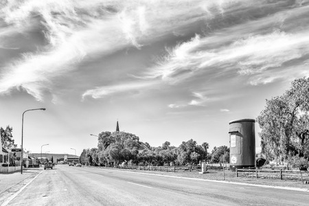 CALVINIA, SOUTH AFRICA, AUGUST 30, 2018: A street scene in Calvinia in the Northern Cape Province. The 6m high Flower Postbox, originally a water tank,  is visible. Monochromeのeditorial素材