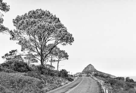 CAPE TOWN, SOUTH AFRICA, AUGUST 9, 2018: The road leading to the top of Signal Hill in Cape Town. Lions Head, people and vehicles are visible. Monochromeのeditorial素材