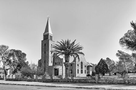 DE AAR, SOUTH AFRICA, AUGUST 6, 2018: A street scene, with the Reformed Church, in De Aar in the Northern Cape Province. Monochromeのeditorial素材
