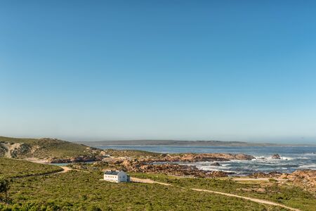 PATERNOSTER, SOUTH AFRICA, AUGUST 21, 2018: A view of Tietiesbaai Caravan Park in the Cape Columbine Nature Reserve near Paternoster. Ablution buildings and a motorhome are visibleのeditorial素材