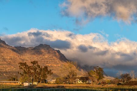 KROMRIVIER, SOUTH AFRICA, AUGUST 25, 2018: Sunrise at Kromrivier Cederberg Park, a holiday resort in the Cederberg Mountains. The historic water mill is visible on the leftのeditorial素材