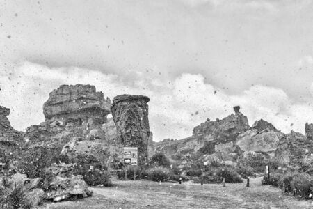 STADSAAL CAVES, SOUTH AFRICA, AUGUST 26, 2018: Snow is falling at the parking area at the Stadsaal Caves in the Cederberg Mountains of the Western Cape Province. An information board is visible. Monochromeのeditorial素材