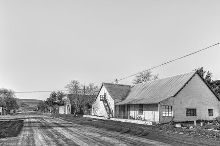 SUTHERLAND, SOUTH AFRICA, AUGUST 8, 2018: A street scene, with old houses with lofts, in Sutherland in the Northern Cape Province. Monochromeのeditorial素材