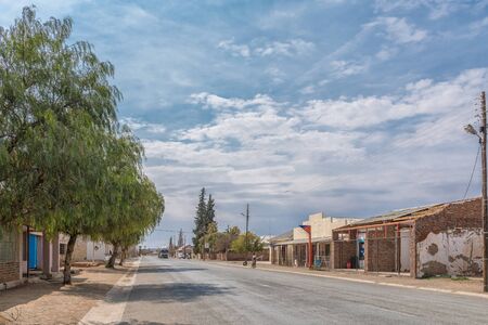 STRYDENBURG, SOUTH AFRICA, SEPTEMBER 1, 2018: A street scene, with businesses, vehicles and people, in Strydenburg in the Northern Cape Provinceのeditorial素材